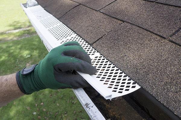 gutter guards act as a barrier, allowing water to flow into the gutters while keeping leaves and debris out